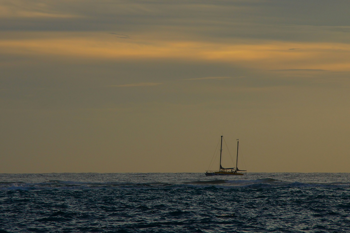 Sailboat making way at sunset