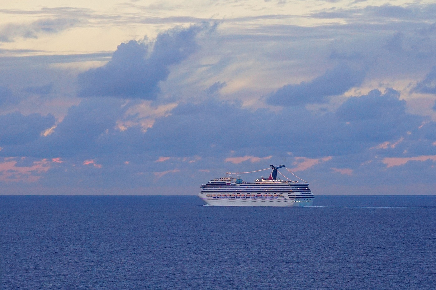 Carnival ship sailing at dusk