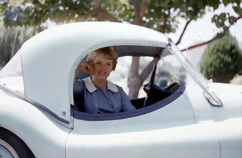 Carol in a Jaguar convertible hardtop, 1960