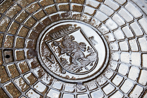 Wet manhole cover with St. Christopher, Vilnius
