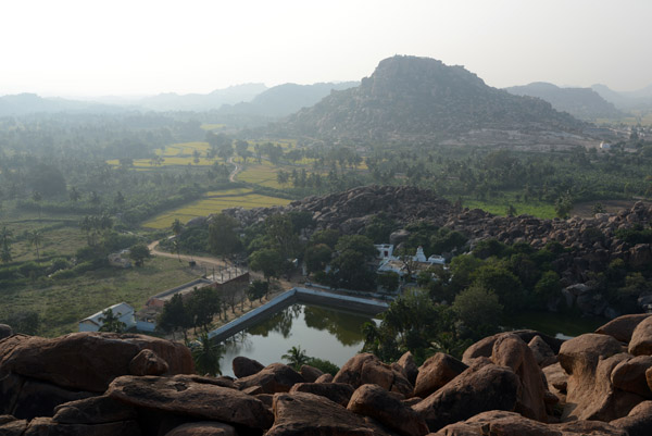 Looking down on the small Lakshmi Temple and water tank at the base of the fortress of Anegondi