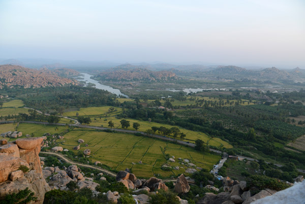 View across the rice fields and Tungabhadra River to Hampi
