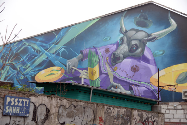 Mural of a bull dressed in purple eating with fork and knife, Kazinczy utca 43, Budapest