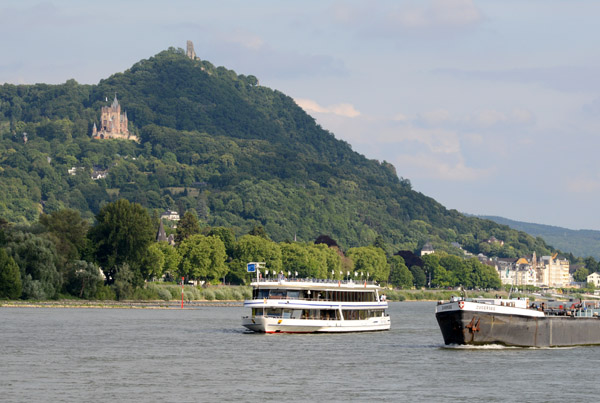 Tourist boat and a Swiss freighter on the Rhine with the Siebengebirge