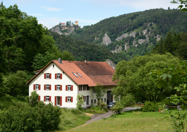 Large farmhouse along the Donauradweg with Schloss Bronnen in the distance