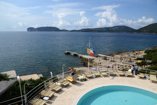 The pool of the Hotel El Faro with Capo Caccia