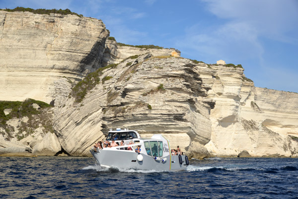 Tour boat cruising along the cliffs of Bonifacio