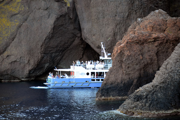 Tour boat among the cliffs and rocks of the Scandola Peninsula