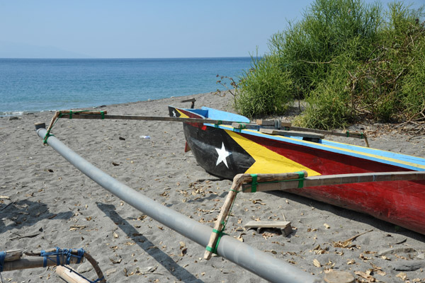 A fishing canoe painted with the flag of Timor-Leste