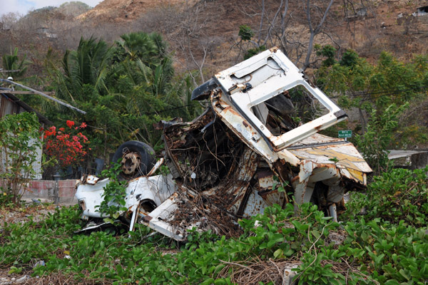 A managled wreck left on the side of the road near Metiaut Beach, Dili