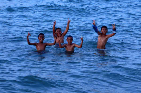 Boys swimming in front of the dive shop