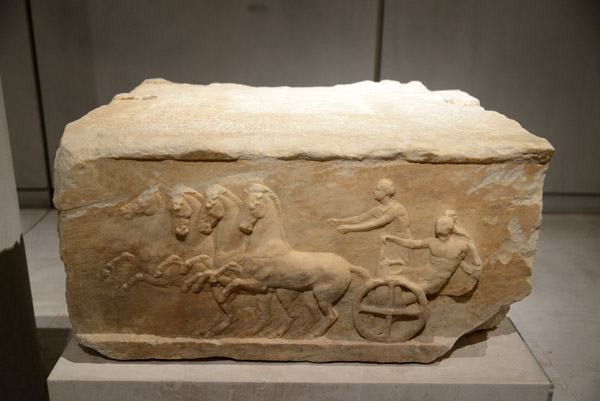 Statue base depicting an apobate race, late 4th-early 3rd C. BC