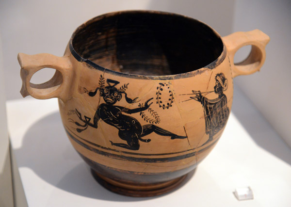 Kabeiric skyphos, nude wreathed initiate dancing to a double flute, Thebes, 5th C. BC
