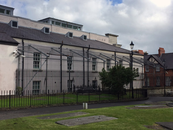 Brutal looking caged prison yard on the back side of Londonderry Court House