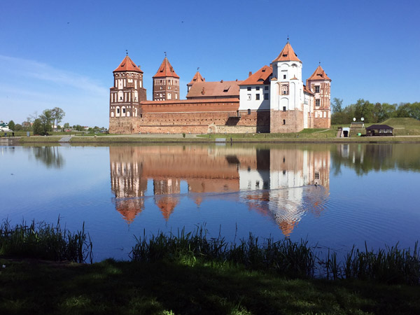 Mir Castle reflecting in the still water of the castle pond