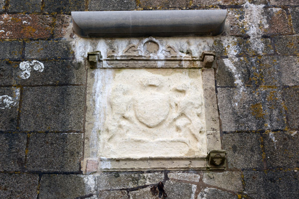 Weather-worn coat-of-arms of Elizabeth I over the entrance to Castle Cornet