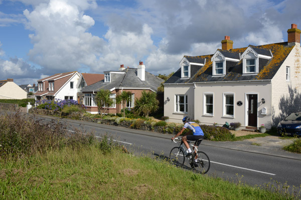 Cyclist passing Rock View Cottage, Guernsey 
