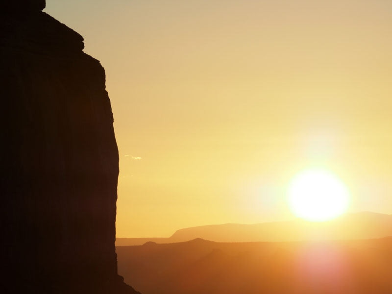 The sun clears the horizon at Monument Valley