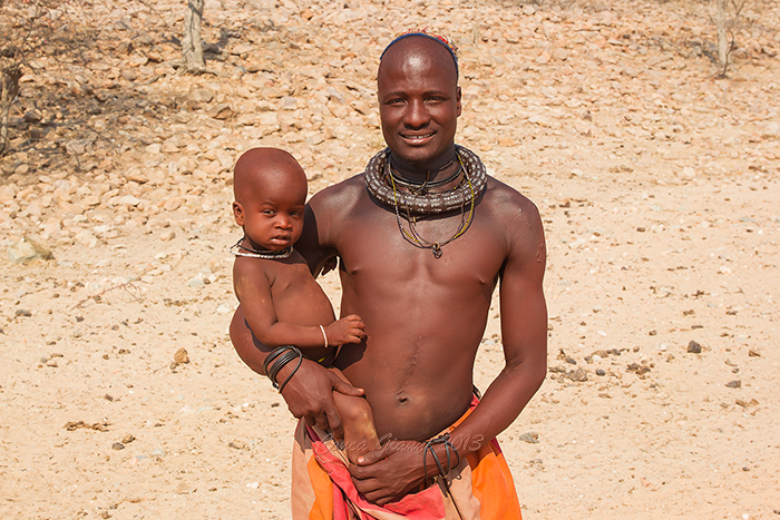 Himba man with baby