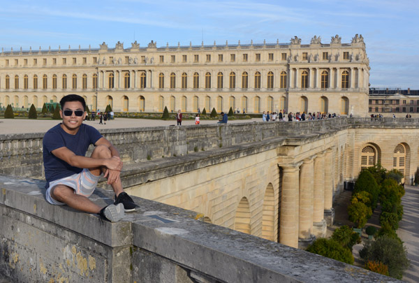 Sitting on the edge of the wall overlooking the Orangeries, Palace of Versailles