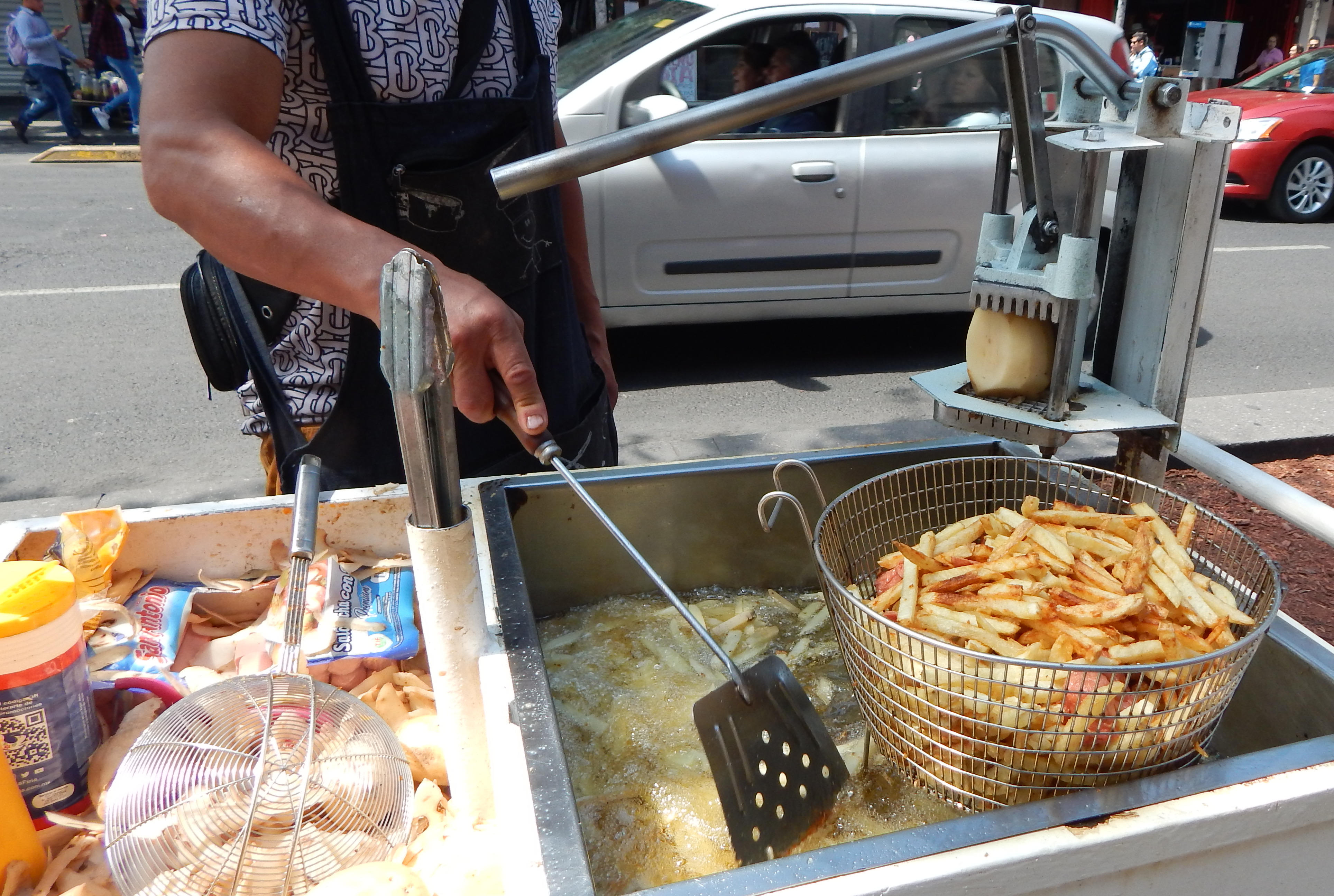 Freshly made french fries on sidewalk