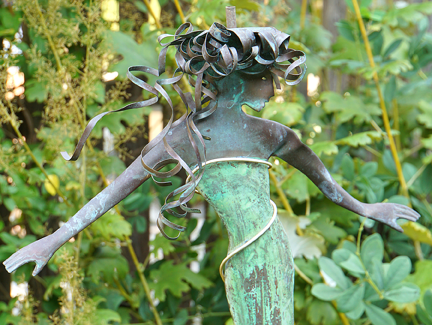 Curly-haired mermaid sculpture.