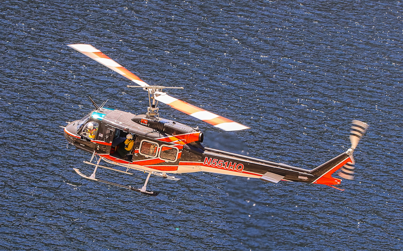Search and Rescue Helicopter flies over the reservoir in the Hetch Hetchy Valley of Yosemite NP