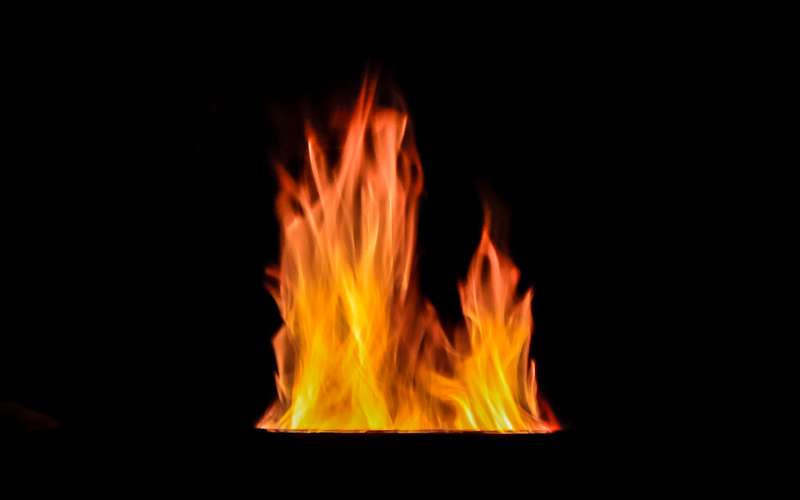 Fire leaps from a fire pit on the banks of Chickamauga Lake 