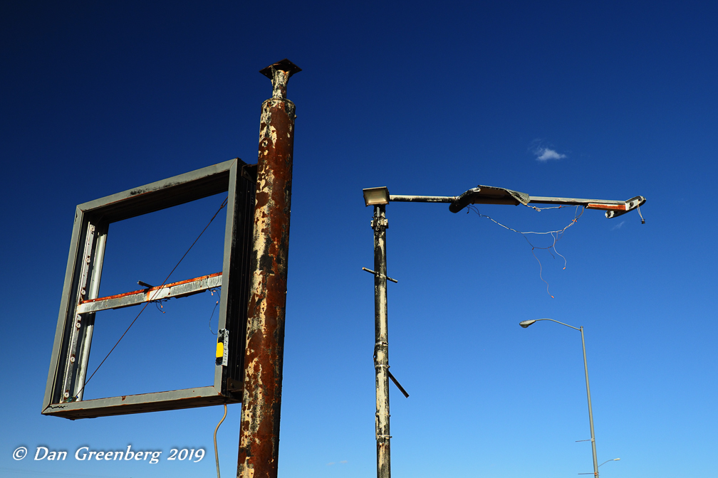 Old Sign Posts, Street Light and a Single Cloud