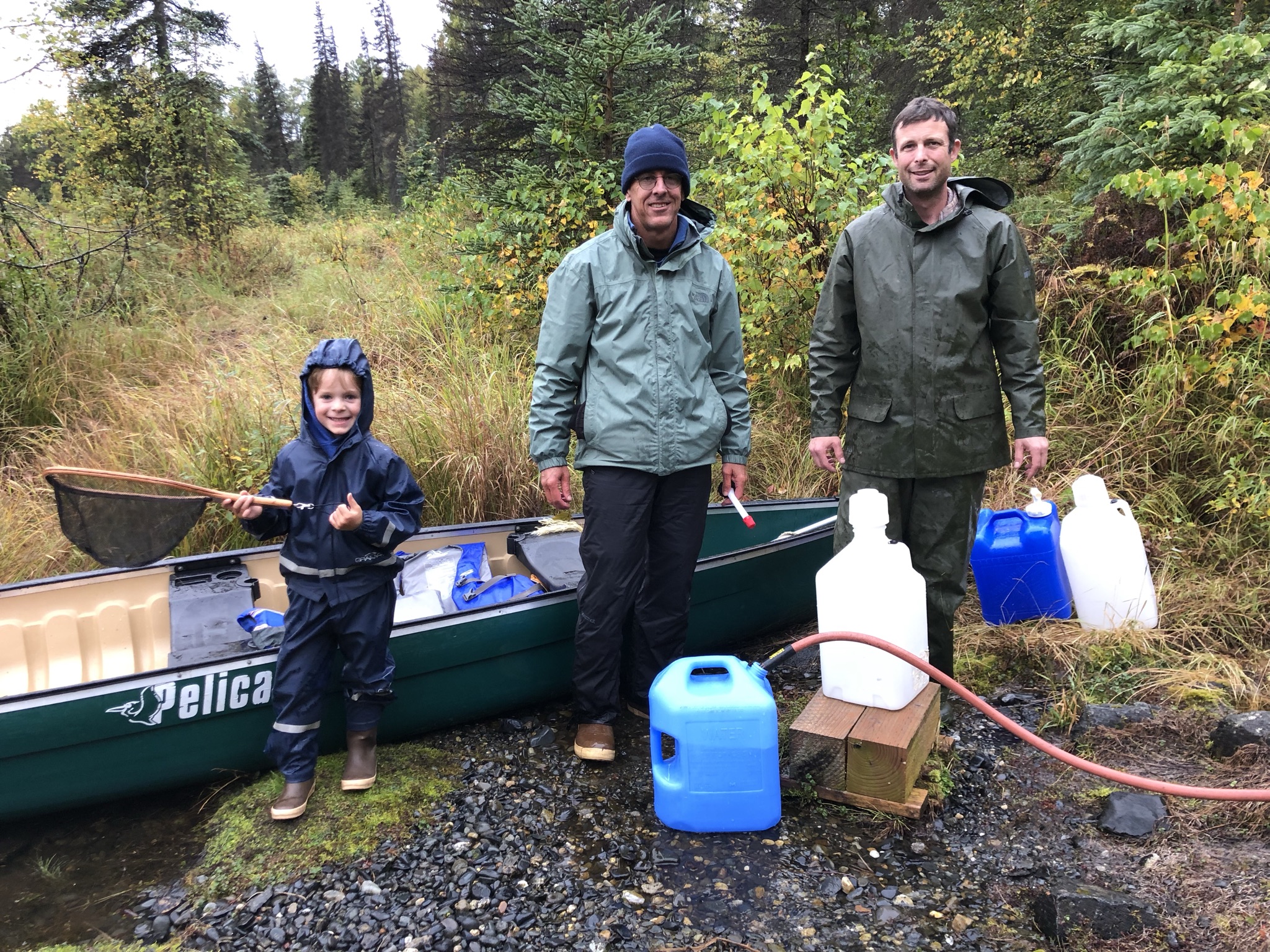 The boys filling up water jugs at the spring