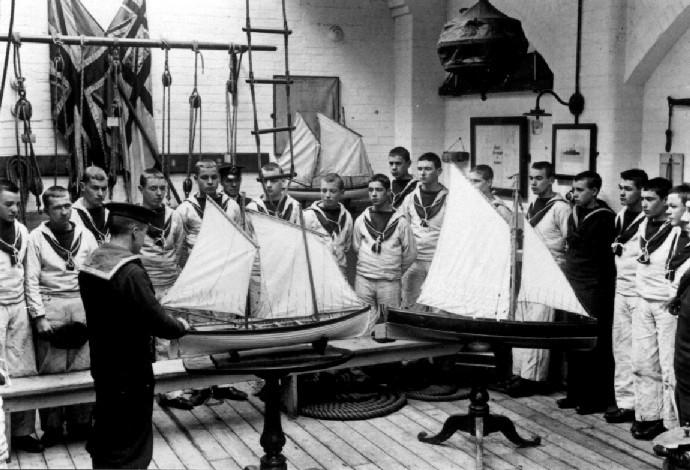 UNDATED - SEAMANSHIP SCHOOL, BOYS BEING GIVEN SAILING INSTRUCTIONS ON A LUGGER RIGGED CUTTER.jpg