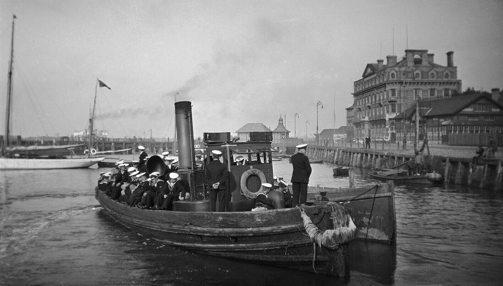 UNDATED - GANGES BOYS AND CPOs AND POs ON STEAM LAUNCH AND LARGE ROWING BOAT OFF HARWICH WATERFRONT.jpg