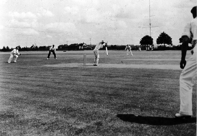 UNDATED - DICKIE DOYLE, SHIPS COMPANY CRICKET MATCH, NOTE THE SIGNAL TRAINING MAST BY THE IPSWICH ROAD.JPG