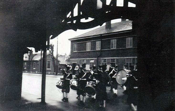 1954, 9TH JUNE - PETER STUDD, BAND MARCHING ON THE QD PAST THE LCW..jpg