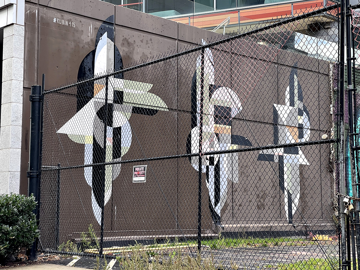 Mural behind a wire fence
