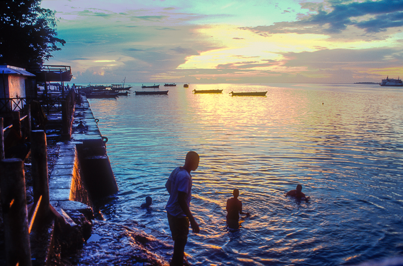 Young men diving at dusk, Zanzibar