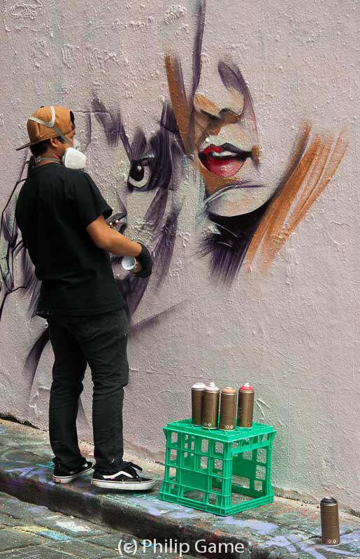 Street artist at work in Hosier Lane, Melbourne