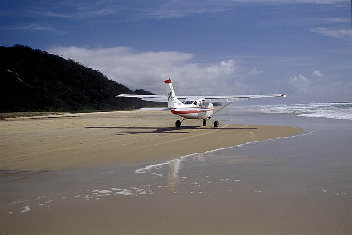 Light aircraft landing on the 75 Mile Beach, Fraser Island