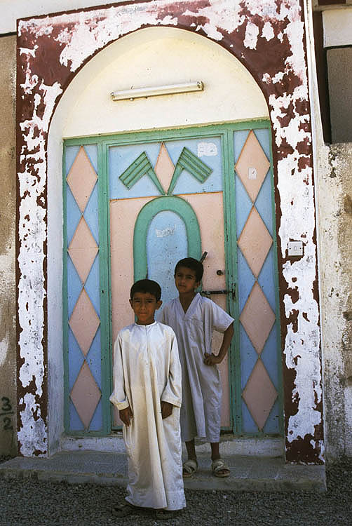 Gulf Arab boys at the gate of the family home, Wadi Siji, Sharjah