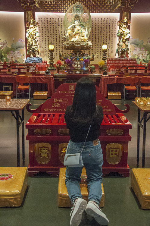 Worshipper at the Buddha Tooth Relic Temple, Chinatown, Singapore