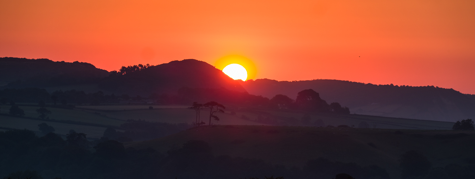 Sunrise over Peak Hill from our garden