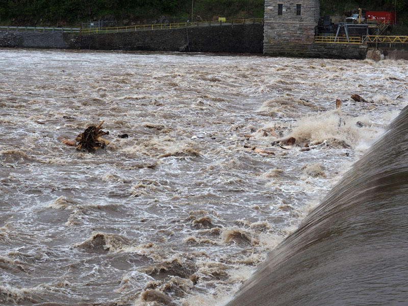 The flooding river flows over Dam 4