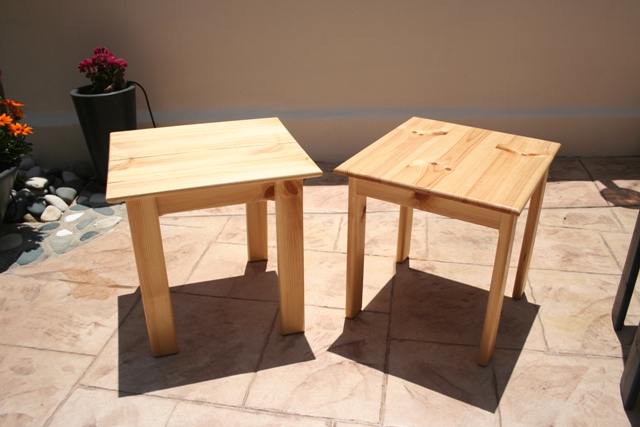 a pair of garden tables