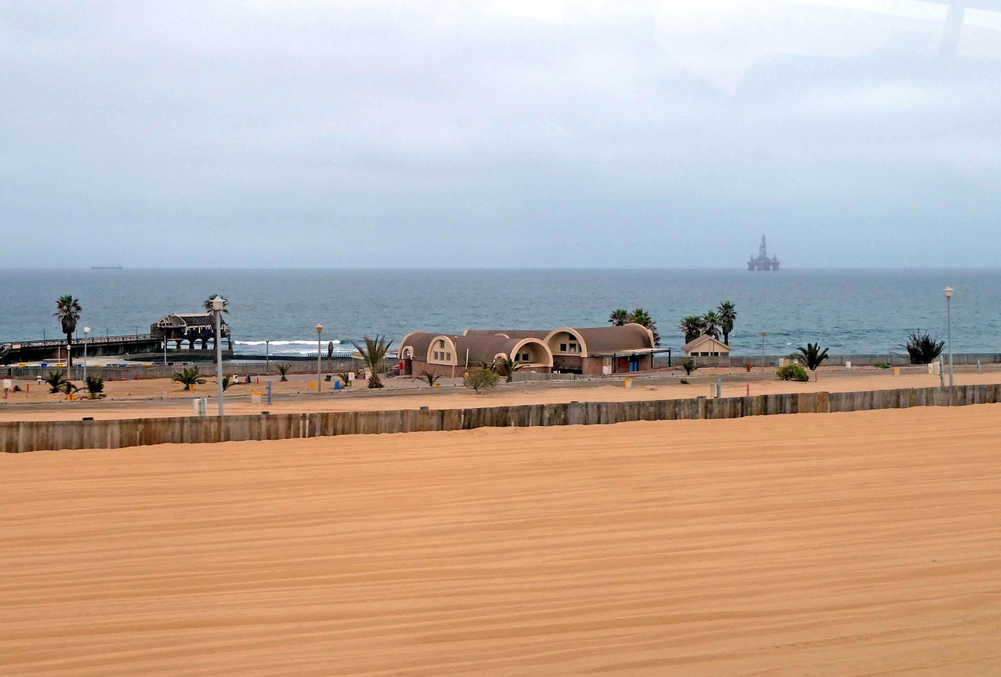 Houses and offshore oil rig between Walvis Bay and Swakopmund, Namibia.JPG