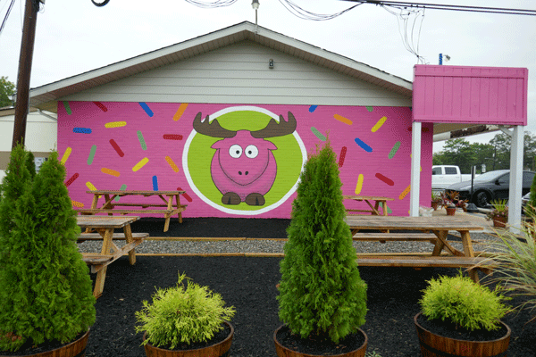 its a moose. no... its a mural.  NO.  ITS A SIGN.
