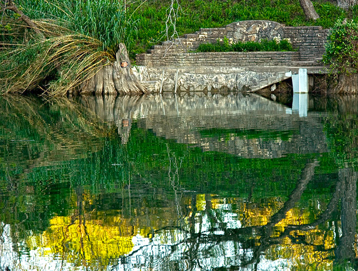 Rock dock and reflection on Blanco River 