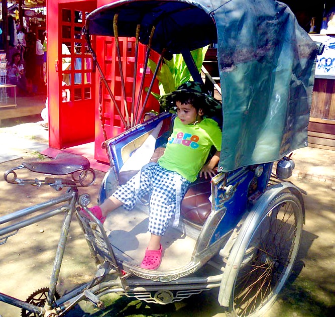 Ace in an old trishaw at Amphawa