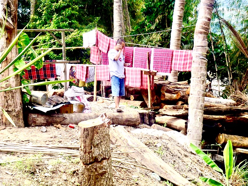 Laundry man and mobile phone, Luang Prabang