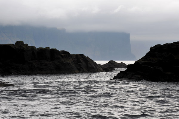 Coastal rocks, Streymoy, with Vgar in the distance
