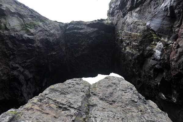 Passing under a natural arch, west coast of Streymoy, Faroe Islands